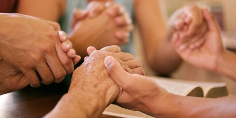Elderly Holding Hands Together in Prayer at Assisted Living Facility
